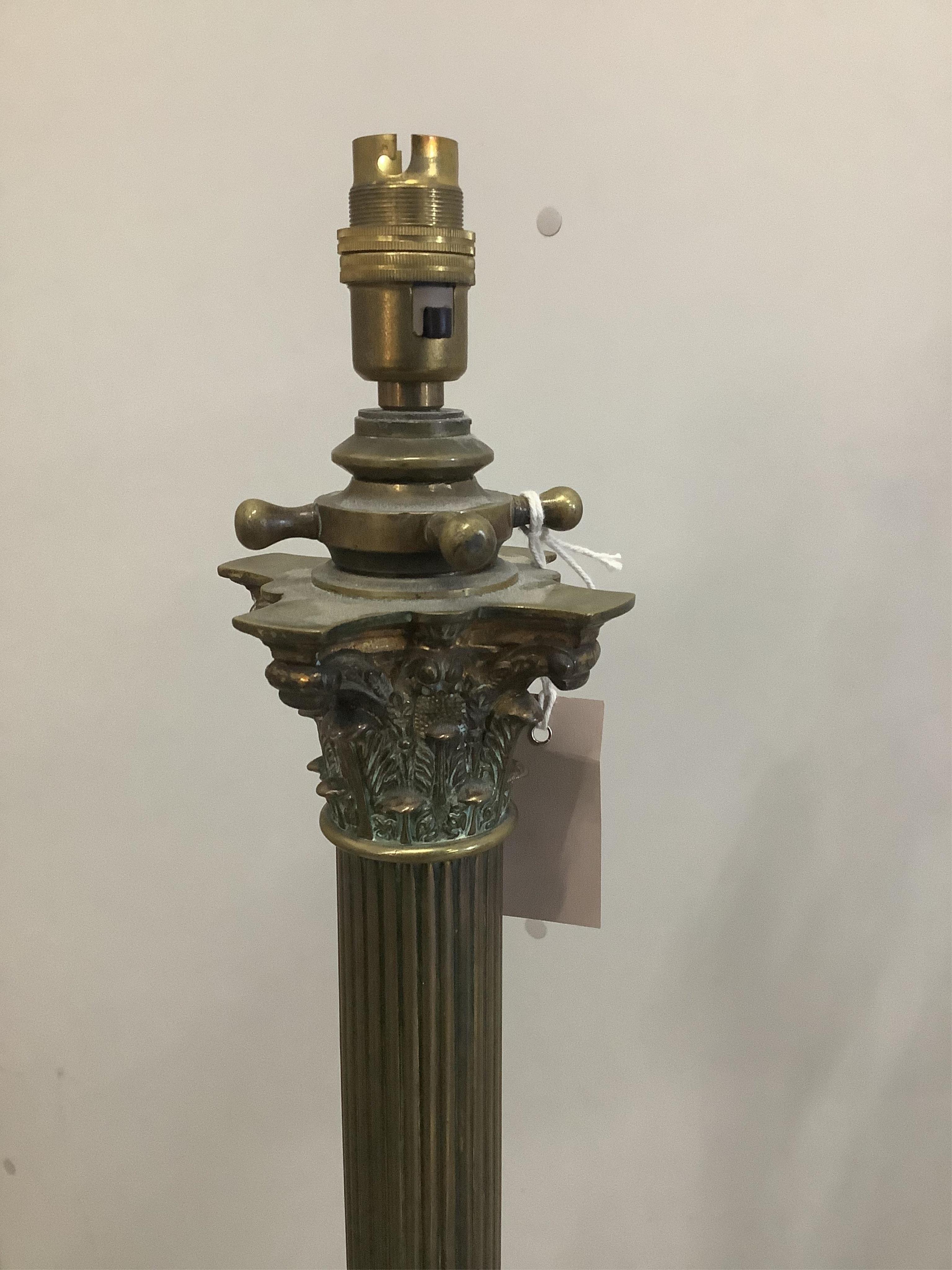 An early 20th century brass Corinthian column telescopic standard lamp. Condition - fair